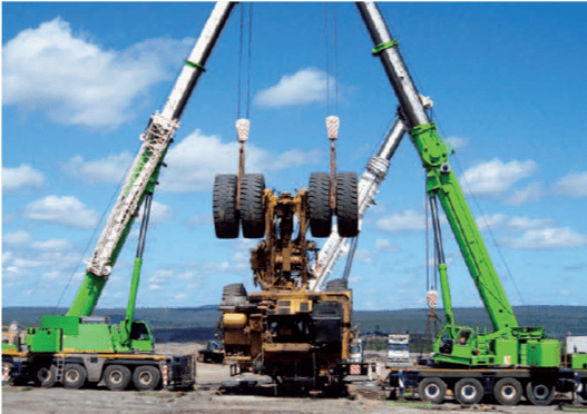 Truck Recovery with two green crane pulling at Field Engineers